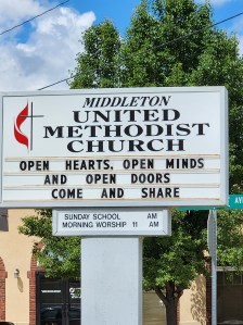 Image of church sign open hearts open minds open doors come and share